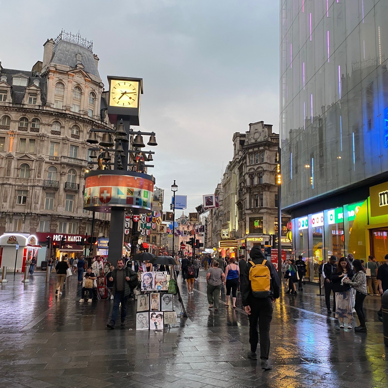 Rainy daytime street scene reflecting colors and buildings in Leicester Square, London. 