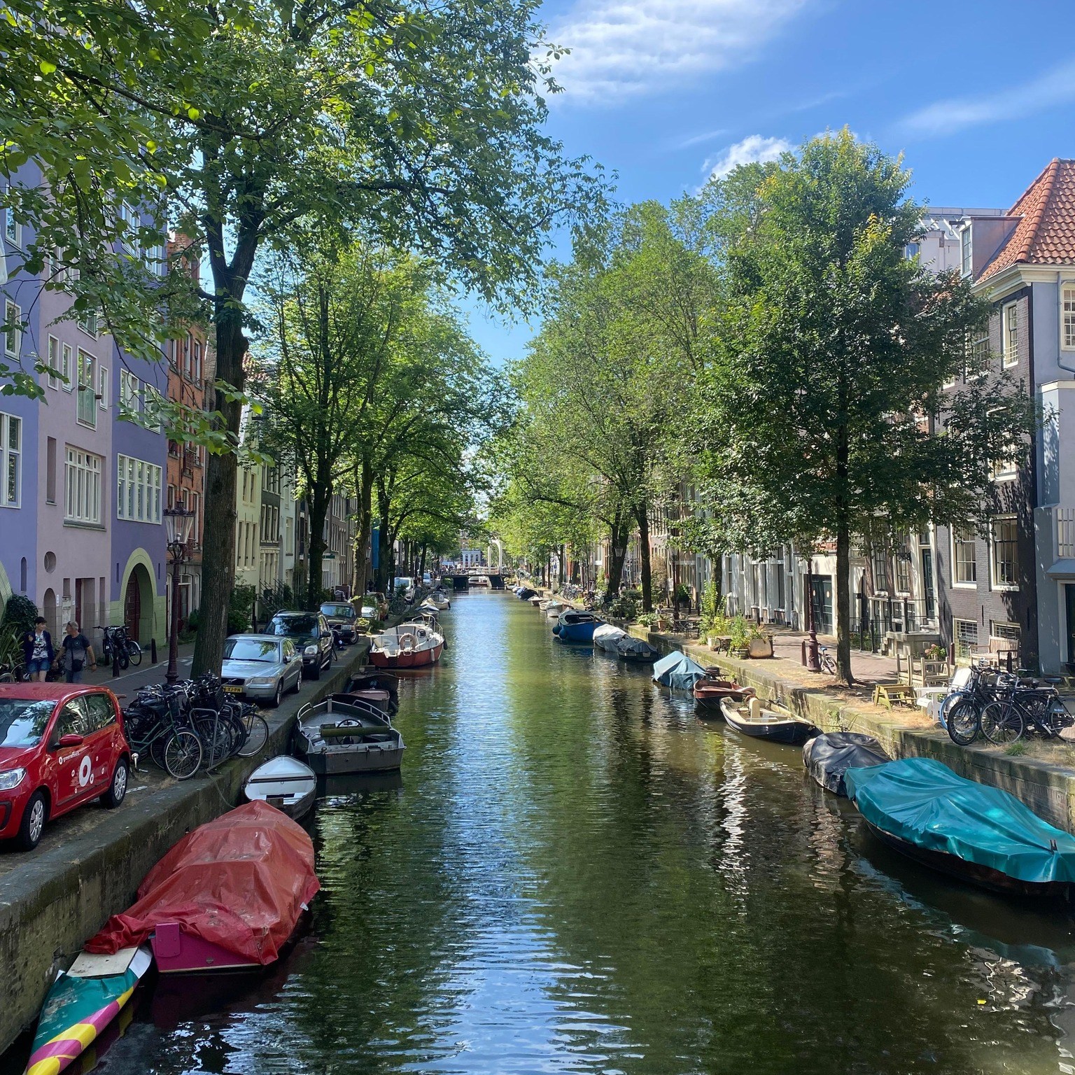 Can with colorful boats lining each side of the Amstel River. 