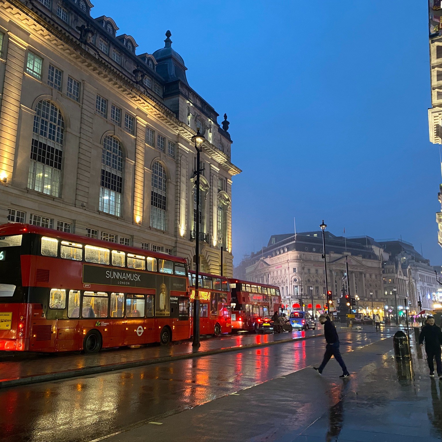 Rainy night street scene in London on the Strand.