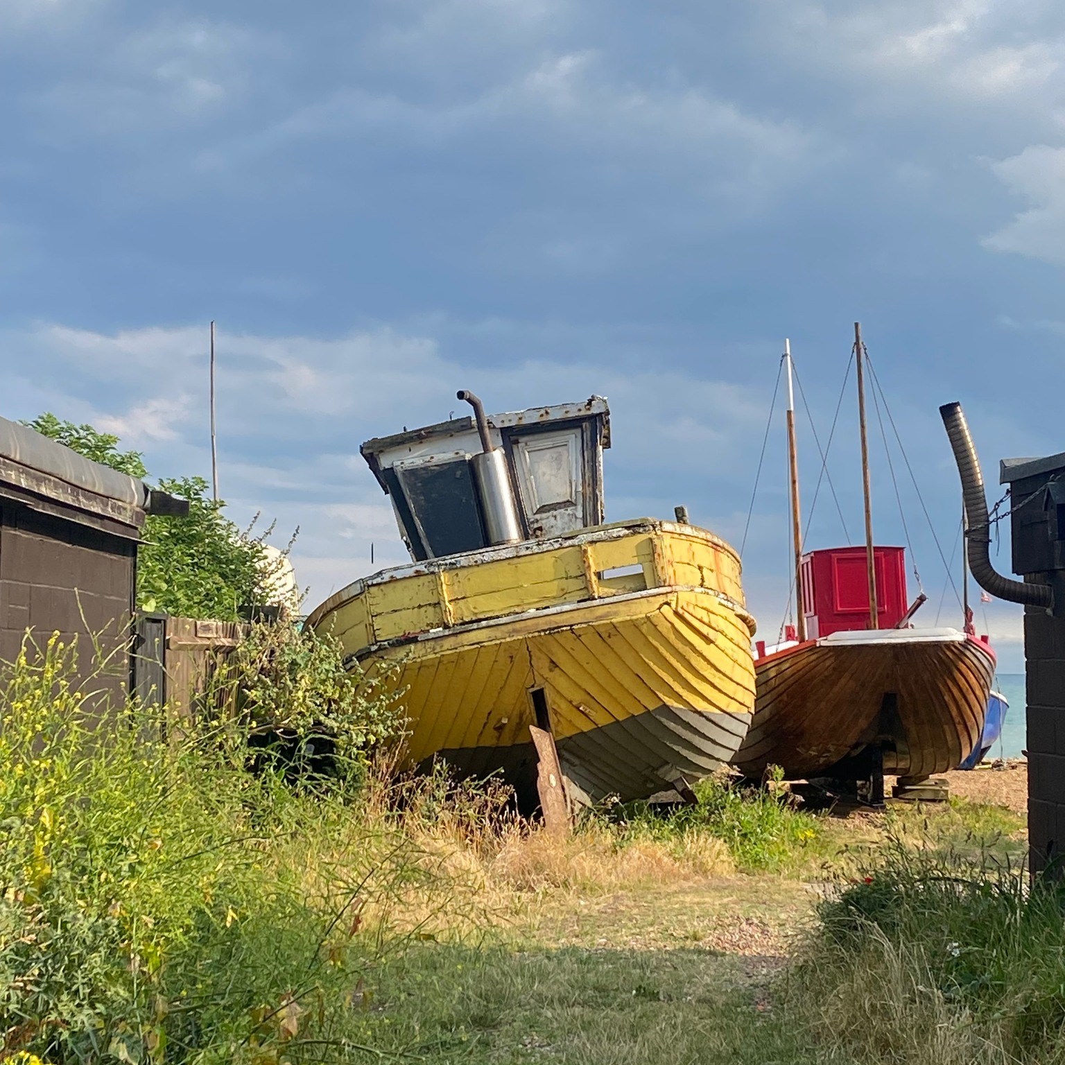 Old wooden fishing boat on dry land.