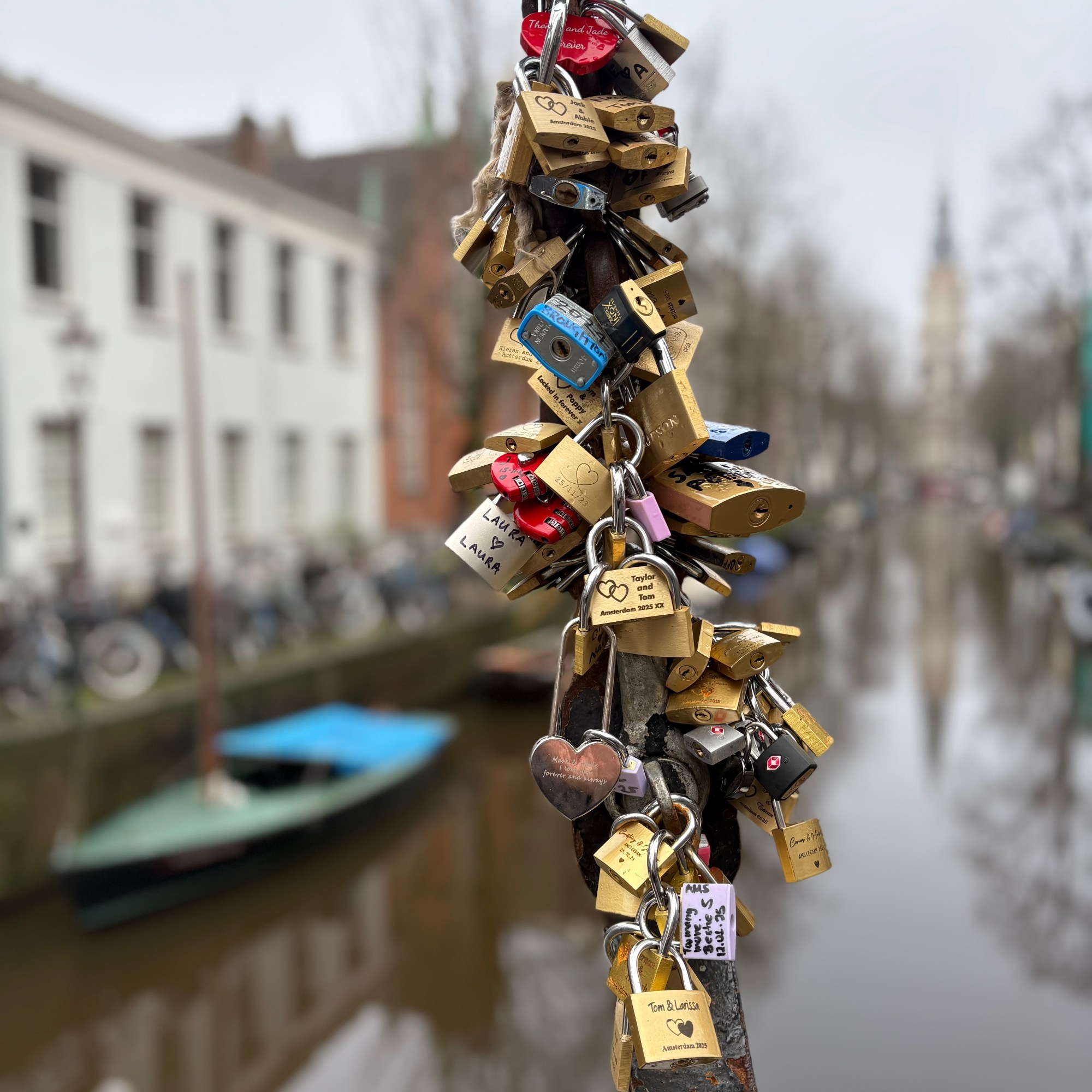 Locks affixed to truss of bridge with love notes engraved on them. Amsterdam. 